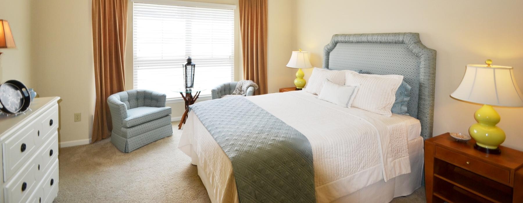 a bedroom with a bed and lamps