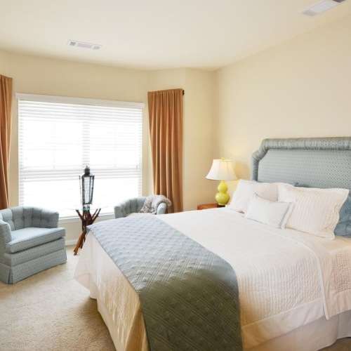 a bedroom with a bed and lamps
